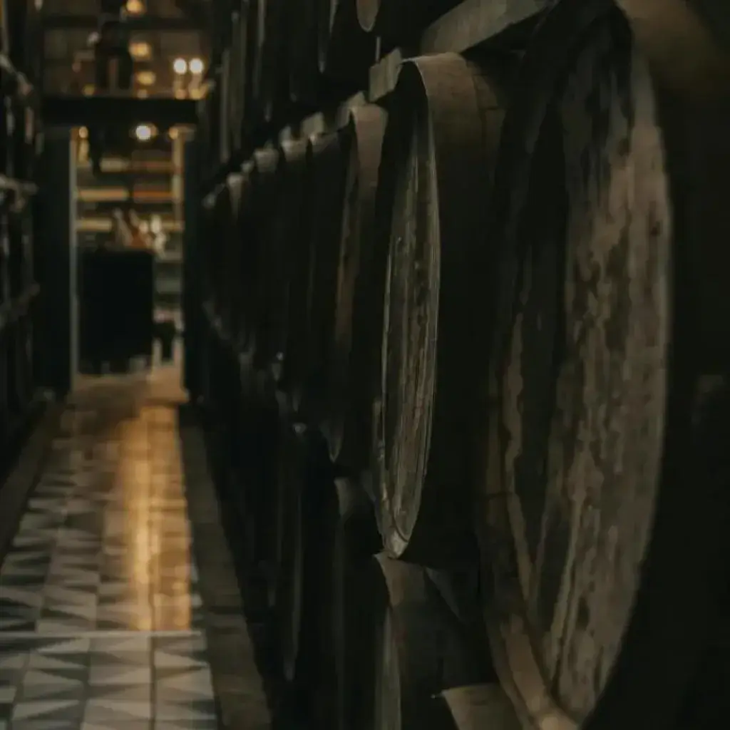 Oak casks in a dramatically lit warehouse